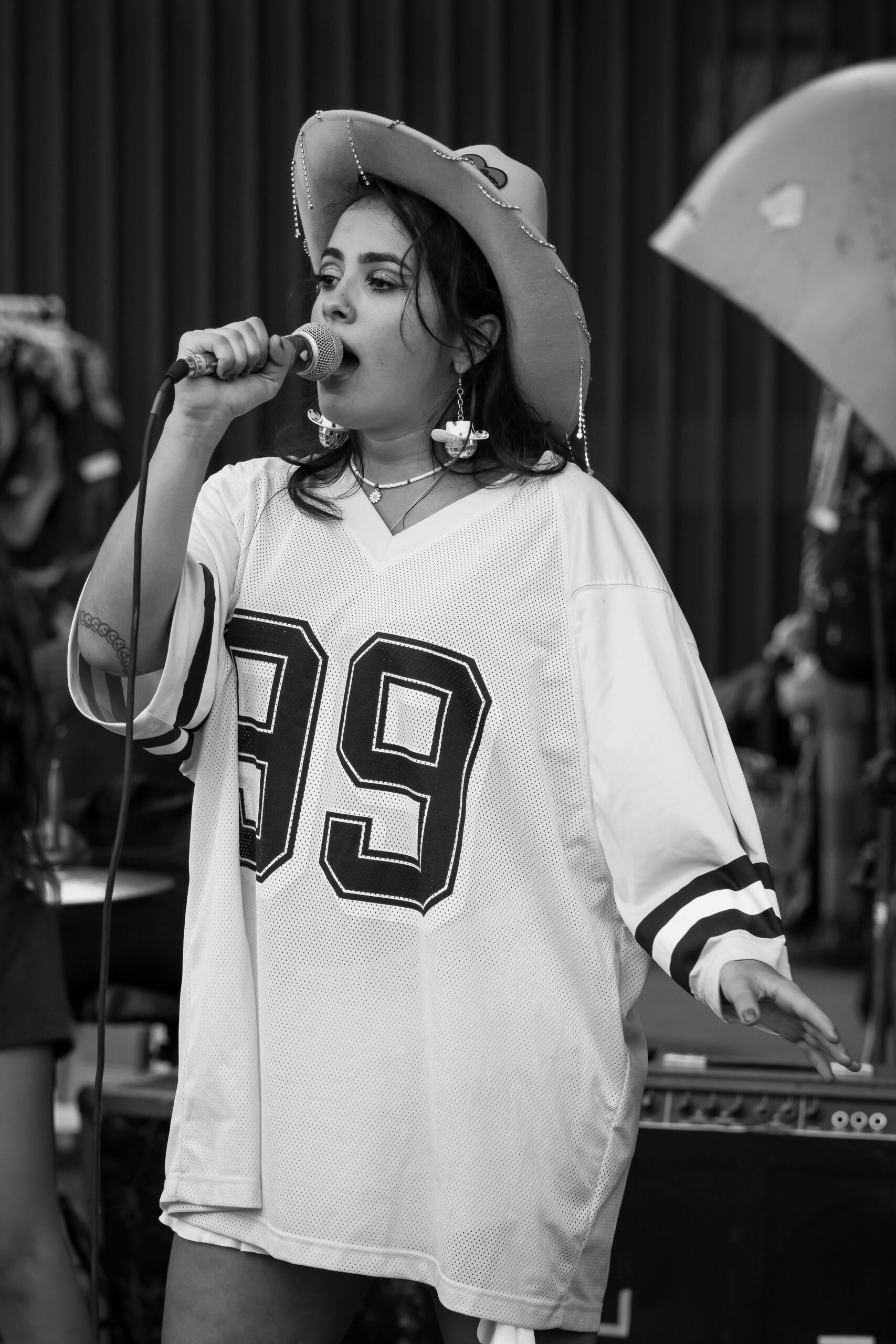 Energetic singer at outdoor street performance in monochrome